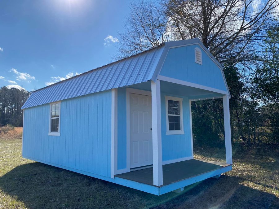Sky-blue lofted shed with a covered end porch