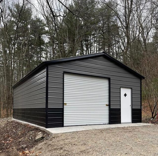 Two-tone charcoal steel garage with a roll-up door